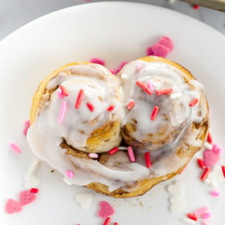 Heart Cinnamon Rolls recipe and tutorial for Valentine's Day - Quick and easy and totally adorable Heart Cinnamon Rolls make a festive Valentine's Day breakfast that the kids will love!