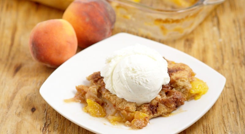 Southern Peach Cobbler Recipe - an easy, yummy dessert recipe. Fresh or canned sweet peaches covered covered in butter, brown sugar and spices and topped with a simple moist cobbler batter and cinnamon sugar topping. Great for parties and holidays! This is so delicious with ice cream on top. It adds just the right amount of creamy.