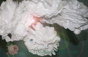 Sparkly tissue paper poms poms fit for a princess. Perfect for birthday parties or nursery decor. Plus a money-saving tip. From TheGraciousWife