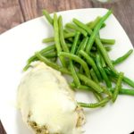 Cheesy Garlic Herb Chicken - easy and cheesy baked chicken dinner recipe with lots of herbs and garlic, and best of all gooey CHEESE!
