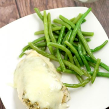 Cheesy Garlic Herb Chicken - easy and cheesy baked chicken dinner recipe with lots of herbs and garlic, and best of all gooey CHEESE!