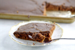 Chocolate Texas Sheet Cake  Recipe -  An easy homemade chocolate cake recipe from scratch.  This cake is THE BEST! Rich, chocolate, and moist!  The richest, most delicious chocolate cake on the PLANET with moist chocolate cake and a decadent fudge frosting. An absolute must-try for chocolate lovers!