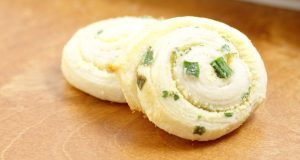 Parmesan Scallion Pinwheels Recipe- An easy, quick, and delicious appetizer recipe idea. Great for a party, Christmas, or a crowd. The buttery goodness of crescent rolls with Parmesan cheese and scallions for a pop of flavor.