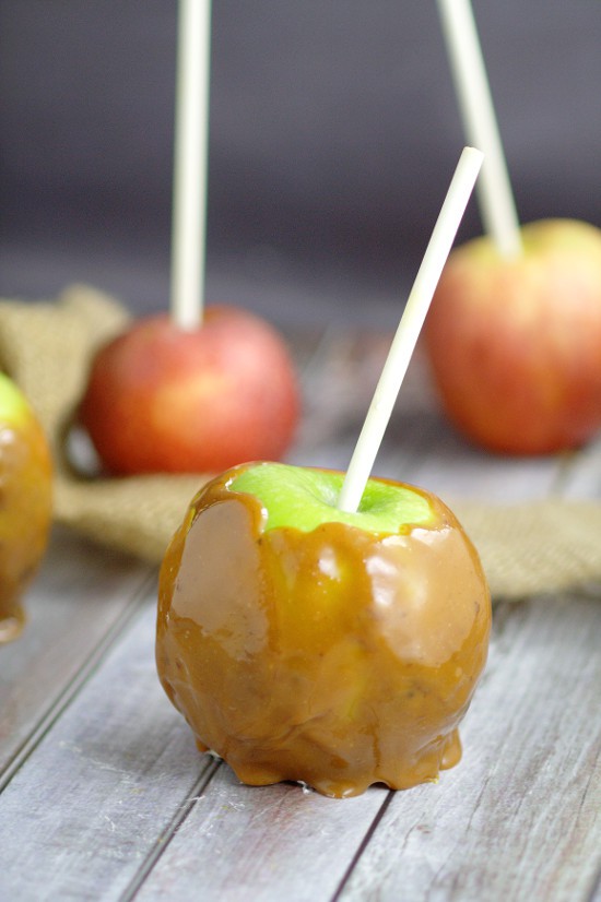 Homemade Taffy Apples are a perfect Fall treat with homemade, gooey and sweet caramel wrapped around fresh, tart apples that the whole family will love.  Caramel Apples from scratch are amazing! Love this for a Fall dessert recipe.
