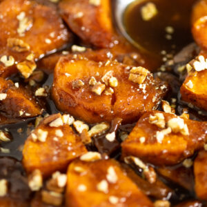 Candied sweet potatoes topped with finely chopped pecans.