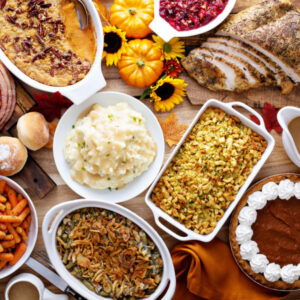 Thanksgiving side dishes on a wooden table with Fall decorations