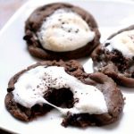 Hot Cocoa Cookies replicate the delightful feeling of a warm cup of cocoa on a cold day, with warm and gooey chocolate cookies topped with a toasted marshmallow.