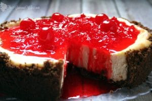 This Gingersnap Cherry Cheesecake has a gingersnap crumb crust, classic cheesecake filling, and a sweet cherry sauce topping.  From TheGraciousWife.com