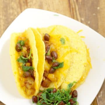 Chorizo Potato Tacos are a quick and easy dinner recipe idea that only takes 30 minutes to make! Crispy potatoes and salty, spicy chorizo are topped with a crisp black bean and cilantro salsa to make a delicious but frugal dinner.