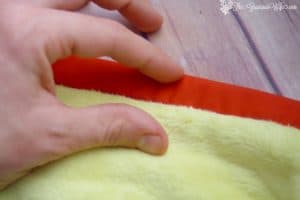 Binding Your Quilt - Part 5 in a 5-part Quilting for Beginners series.  This Basting and Quilting section will walk you through binding your quilt and adding finishing touches to your quilt.  Make your own DIY sewing quilt with this step-by-step tutorial!
