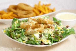 Southwest Salad Recipe with Spicy Honey Mustard Dressing Recipe - an easy salad recipe that's perfect for lunch or dinner. Onion Rings on a salad?! Yes, please!