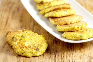 Fried Corn Cakes Recipe - Fried to perfection! What an easy vegetable summer side dish! I think it would be a great way to use up leftover corn on the cob too!
