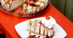 Banana Split Pie Recipe - a no bake pie recipe with graham pie crust, banana swirl ice cream, topped with pineapple, strawberries, chocolate sauce, whipped cream, and of course a cherry! This is so good. It's seriously the perfect summer treat.