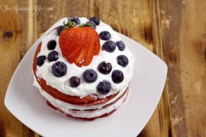 Red Velvet Berry Pancakes Recipe - a delicious breakfast recipe with red velvet pancakes, whipped cream, and fresh berries. The patriotic red white and blue are super cute for a 4th of July breakfast food idea too!