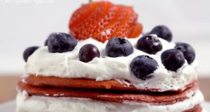Red Velvet Berry Pancakes Recipe - a delicious breakfast recipe with red velvet pancakes, whipped cream, and fresh berries. The patriotic red white and blue are super cute for a 4th of July breakfast food idea too!