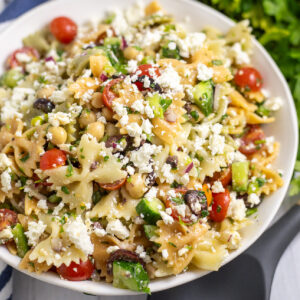 Overhead view of easy feta pasta salad with fresh cherry tomatoes, cucumbers, chickpeas, and lots of feta tossed with a tangy vinaigrette.