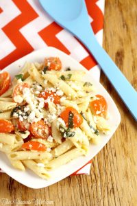This Easy Feta Pasta Salad Recipe with Italian dressing uses just 5 ingredients and is made in just 30 minutes! A perfect salad side dish recipe idea for a picnic, party, or BBQ all Spring and Summer long.  Creamy feta, juicy tomatoes, and fresh basil make this dish amazing! So easy but oh-so-good.