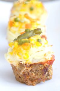Savory meatloaf cupcakes recipe made with the BEST meatloaf recipe and topped with ketchup, mashed potato "frosting" and cheese and veggie "sprinkles."  A delicious single serving family dinner recipe idea.  This would be a good idea for an appetizer recipe for a party too. You could bake them in mini muffin trays!