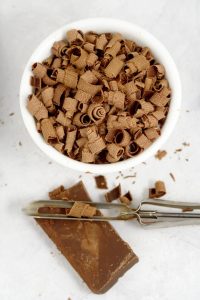 Learn how to make chocolate curls with a potato peeler the easy way for beautiful chocolate curls to complement your desserts!  cooking tips | baking tips | kitchen tips