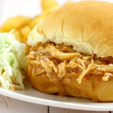 Ridiculously easy Crockpot Barbecue Chicken Sandwiches recipe with just 3 ingredients! Sweet and spicy barbecue with the tang of apple cider vinegar, all in one sandwich in the slow cooker. Top with creamy coleslaw for an extra bit of sweet crunch. Perfect for an easy family dinner idea!