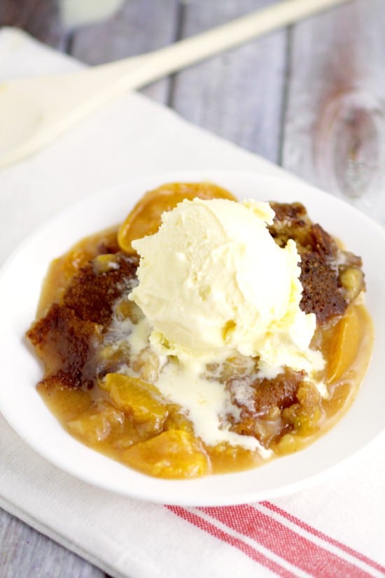 Crockpot Peach Cobbler recipe with warm spiced peaches and a simple, sweet cobbler, topped with a crunch cinnamon-sugar topping in the slow cooker for a super fabulous and easy crockpot dessert recipe. Top with ice cream for an amazing dessert.  Peach cobbler is one of my favorites!