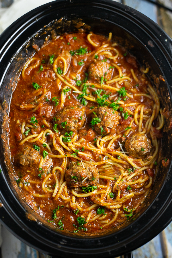 Crock Pot Spaghetti and Meatballs in a slow cooker with fresh parsley on top
