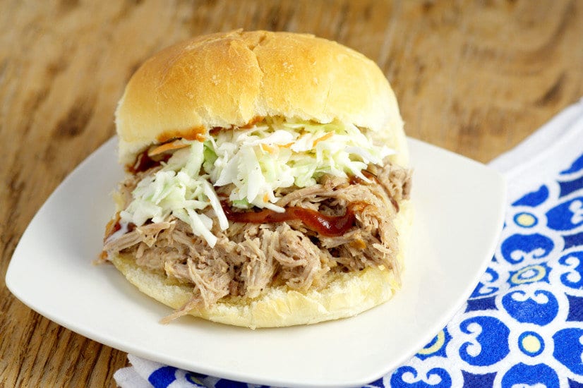 Easy, tangy Slow Cooker Southern Pulled Pork recipe cooked effortlessly in the Crockpot. Top with creamy coleslaw for a bit of sweet crunch and a true Southern experience! This is seriously  one of my favorite recipes of all time! 