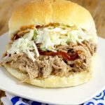 Easy, tangy Slow Cooker Southern Pulled Pork recipe cooked effortlessly in the Crockpot. Top with creamy coleslaw for a bit of sweet crunch and a true Southern experience! This is seriously  one of my favorite recipes of all time! 