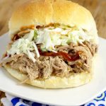 Easy, tangy Slow Cooker Southern Pulled Pork recipe cooked effortlessly in the Crockpot. Top with creamy coleslaw for a bit of sweet crunch and a true Southern experience! This is seriously  one of my favorite recipes of all time! 