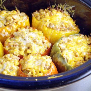 Sweet bell peppers stuffed with a classic cheesy ground beef and rice filling all in the Crockpot, makes these Slow Cooker Stuffed Peppers a family favorite! EVERYTHING goes in uncooked and comes out one delicious, cozy meal.