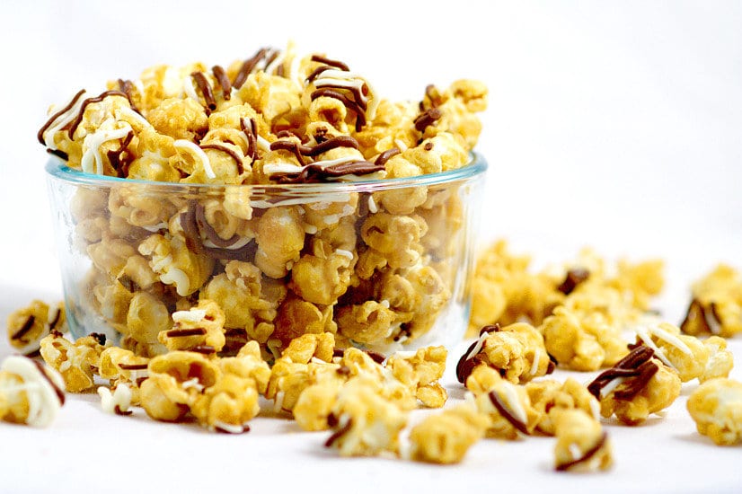 Make your own Homemade Zebra Caramel Popcorn recipe for an easy and sweet snack, treat, or gift idea with warm, sweet oven baked caramel corn, drizzled in milk chocolate and white chocolate for a to-die-for treat.