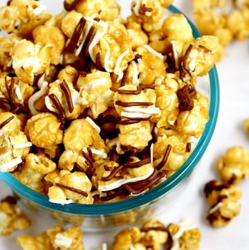 Make your own Homemade Zebra Caramel Popcorn recipe for an easy and sweet snack, treat, or gift idea with warm, sweet oven baked caramel corn, drizzled in milk chocolate and white chocolate for a to-die-for treat.