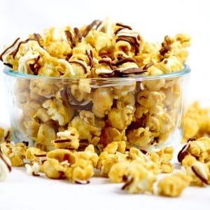 Make your own Homemade Zebra Caramel Popcorn recipe for an easy and sweet snack, treat, or gift idea with warm, sweet oven baked caramel corn, drizzled in milk chocolate and white chocolate for a to-die-for treat.