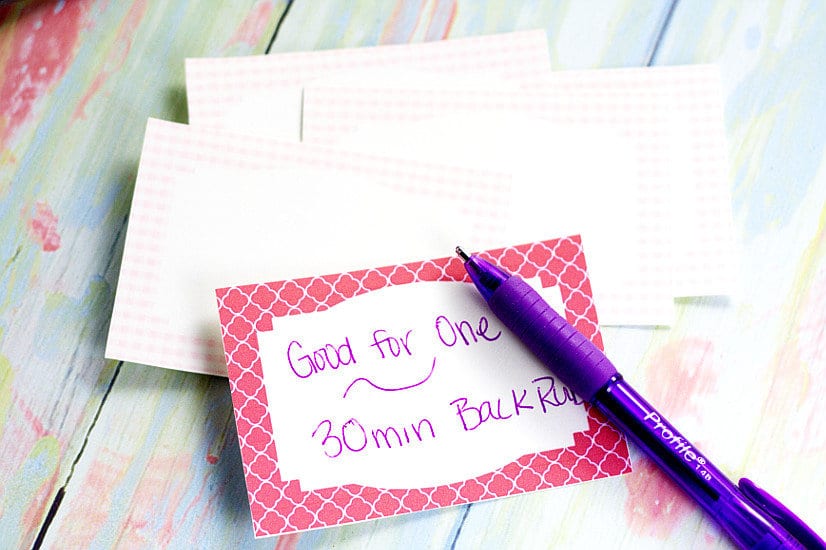 Blank love coupon with "Good for one 30 min back rub" written on it in purple pen