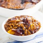 Homemade Bacon Baked Baked Beans are easier to make than you think! Sweet and tangy Homemade Bacon Baked Beans, slow baked with bacon are the perfect summer side dish for your next barbecue or cookout! Yum!