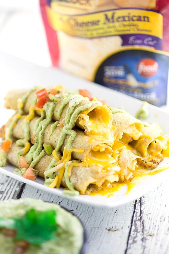 Cheesy Baked Chicken Taquitos recipe - Easy and cheesy Baked Chicken Taquitos will become a yummy, Mexican-inspired family dinner favorite in no time! Serve with the Roasted Creamy Poblano Dip for an extra zesty and a little spicy kick. These look amazing! So cheesy!