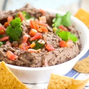 Creamy Black Bean Avocado Dip Recipe - Make this easy and addictive Creamy Black Bean Avocado Dip in just minutes! Makes a healthy snack or heavenly party dip! This is seriously so goodd and ridiculously easy to make.  It goes fast every time we make it and is great game day food and for a crowd.  Can't believe it takes just 8 minutes to make!