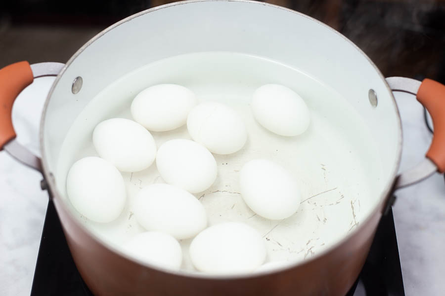 10 eggs in a large pot of water getting ready to be boiled