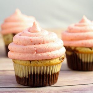 Neapolitan cupcakes are a perfect nostalgic treat with delicately bitter chocolate and sweet vanilla cupcakes topped with fresh strawberry frosting. You'll be whisked away to the dreamy days of childhood.