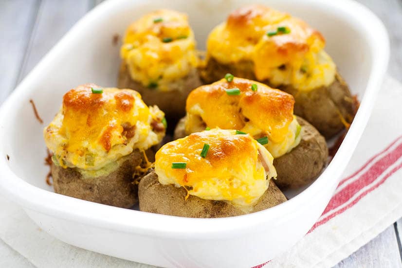 Twice Baked Deviled Potatoes recipe - Named after their eggy-likeness, these Twice Baked Deviled Potatoes are tangy baked potatoes, whipped, and oven-baked to golden perfection. Yummy and easy potato side dish recipe!