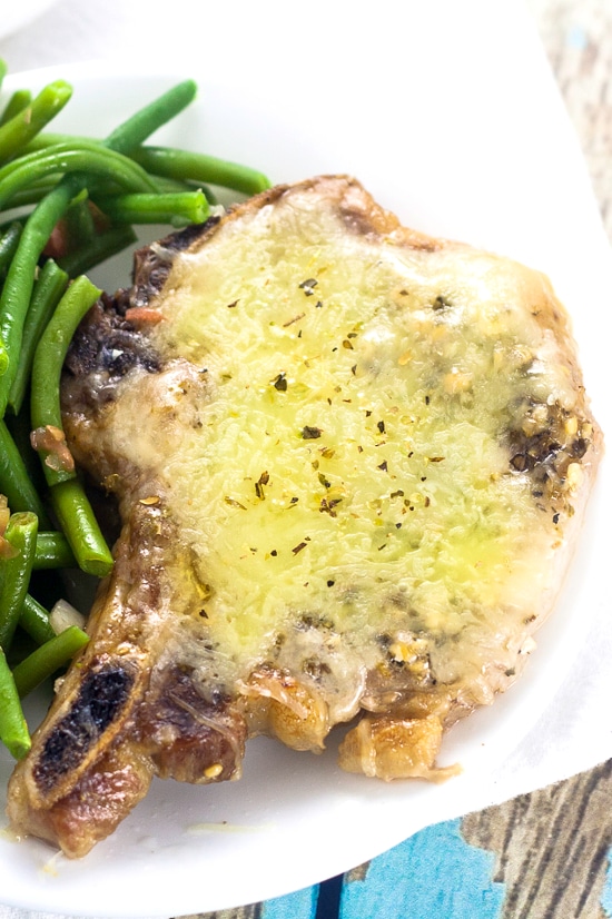 Cheesy Italian Pork Chops Recipe - Juicy, flavorful pork chops, baked in the oven with garlic and Italian seasoning and smothered in cheese in this Cheesy Italian Pork Chops recipe. Make it in just 40 minutes! These are seriously delicious!