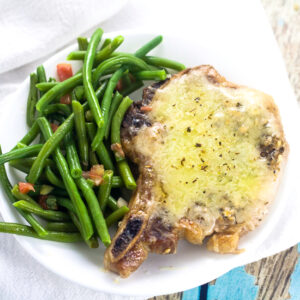 Cheesy Italian Pork Chops Recipe - Juicy, flavorful pork chops, baked in the oven with garlic and Italian seasoning and smothered in cheese in this Cheesy Italian Pork Chops recipe. Make it in just 40 minutes! These are seriously delicious!