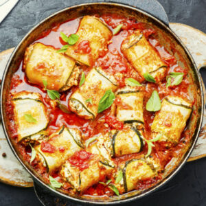 Zucchini rollatinis in a skillet with red sauce
