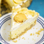No Bake Banana Cream Cheesecake topped with a vanilla wafer on a small white plate.