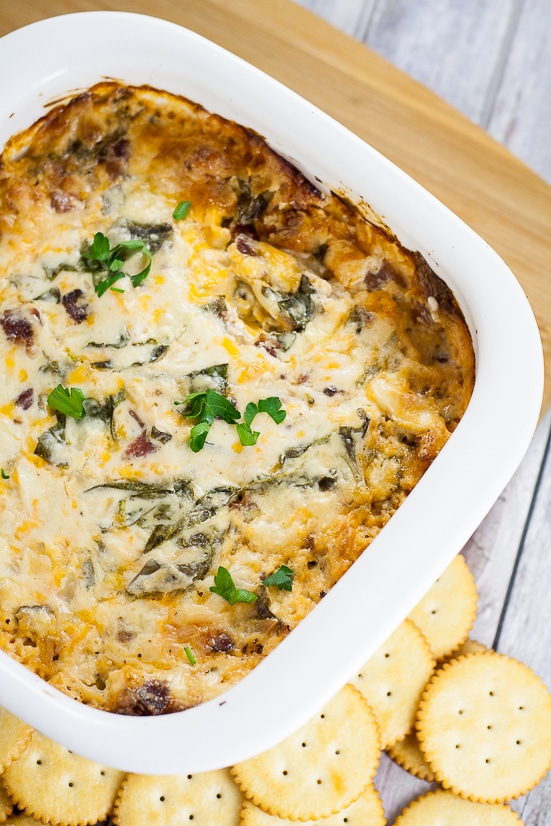 Cheesy Bacon Spinach Dip recipe - Quick, easy, and especially tasty, this Cheesy Bacon Spinach Dip recipe takes just 30 minutes to make, can be made ahead, and is a perfect cozy dip for your next party or gathering! Great easy appetizer recipe for a crowd!
