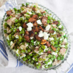 Feta Bacon Peas Recipe - Peas cooked with salty crunchy bacon then tossed with tangy, creamy Feta cheese for a delightful, unique side dish. Make this Feta Bacon Peas quick and easy side dish recipe in just 20 minutes!