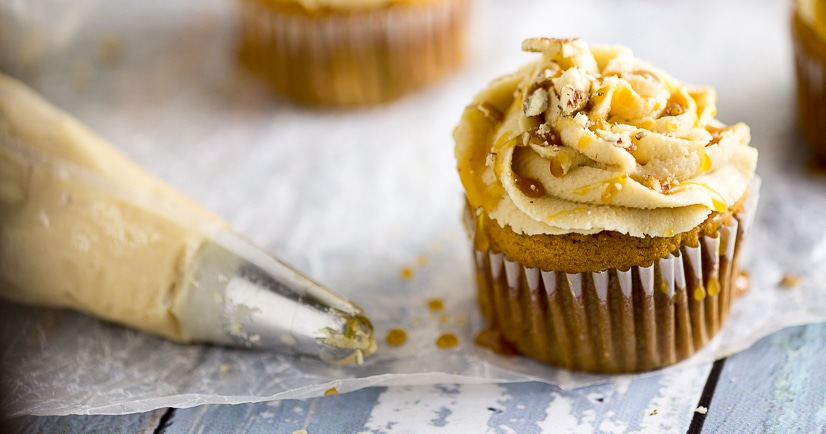 Sweet Potato Pecan Cupcakes Recipe with Caramel Frosting - Rich and moist Sweet Potato Pecan Cupcakes are topped with a sweet caramel frosting. These festive cupcakes have all your favorite Fall flavors and would be a delicious non-pie addition to your Thanksgiving dessert table.