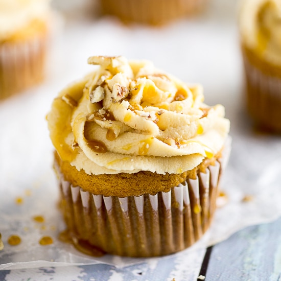Sweet Potato Pecan Cupcakes Recipe with Caramel Frosting - Rich and moist Sweet Potato Pecan Cupcakes are topped with a sweet caramel frosting. These festive cupcakes have all your favorite Fall flavors and would be a delicious non-pie addition to your Thanksgiving dessert table.