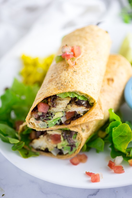 Southwest Chicken Wraps Recipe - Healthy quick and easy Southwest Chicken Wraps with a creamy cilantro lime sauce are a yummy way to eat fresh. Make them for the whole family in under 30 minutes! Super easy and health (or lunch!) recipe!