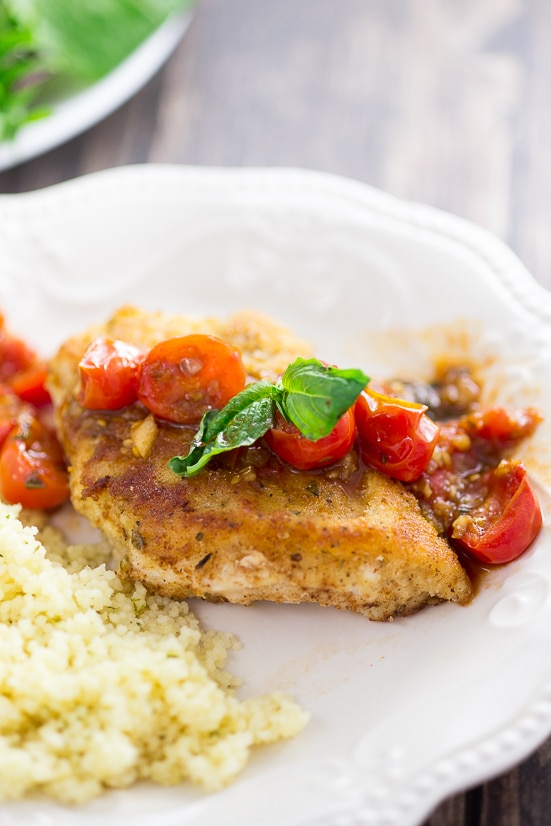 Breaded Chicken with Tomatoes Recipe - Simple but delicious, this Breaded Chicken with Tomatoes recipe has Parmesan Italian breaded chicken breasts with a zesty tomato sauce to make an amazing dinner. 